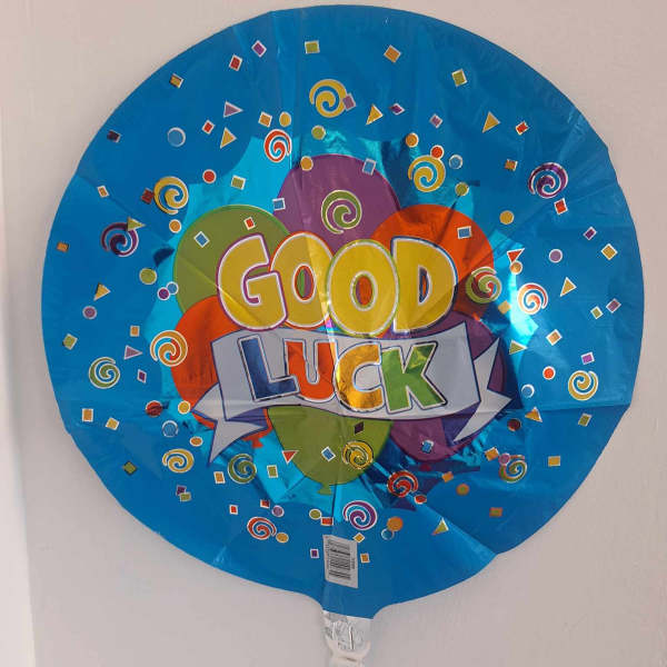 Round blue balloon with "Good Luck" text and confetti graphics