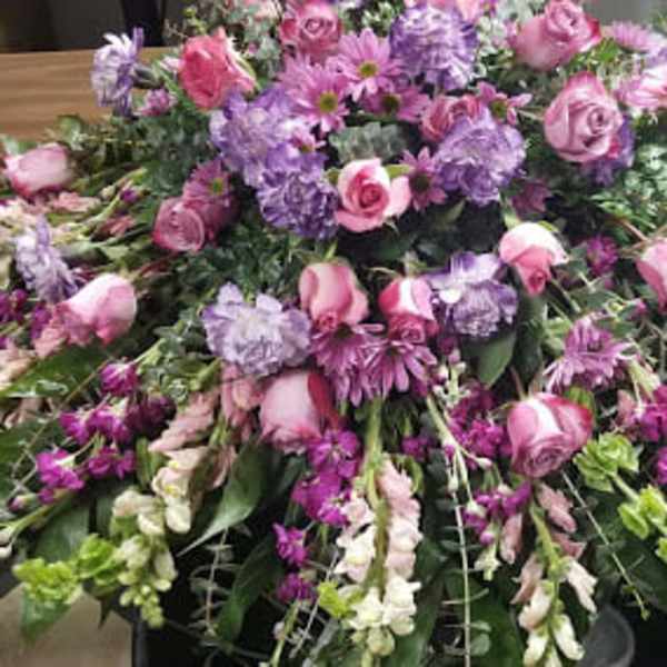 Large pink and purple floral spray on a table