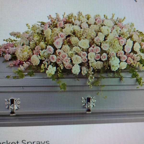 Large pastel floral casket spray with pink and white blooms