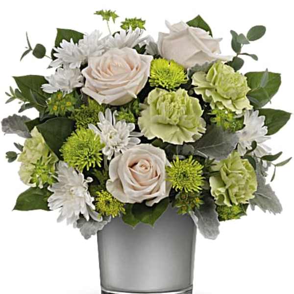 White and green floral arrangement in a clear glass vase
