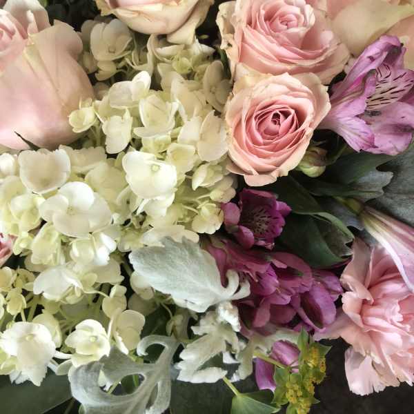 Pink roses with white hydrangeas and purple alstroemeria in a bouquet
