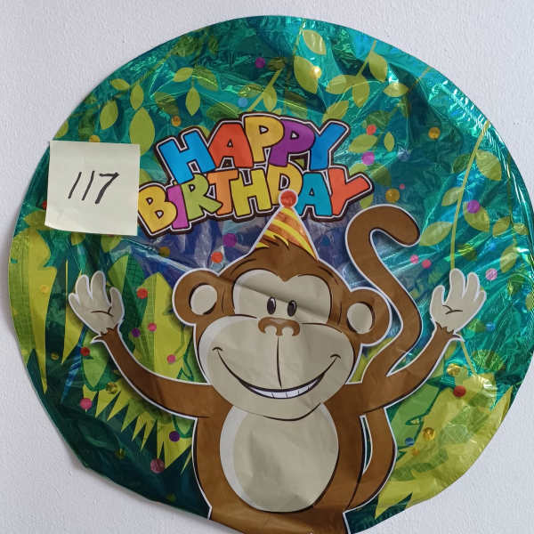 Round birthday balloon with a smiling monkey graphic