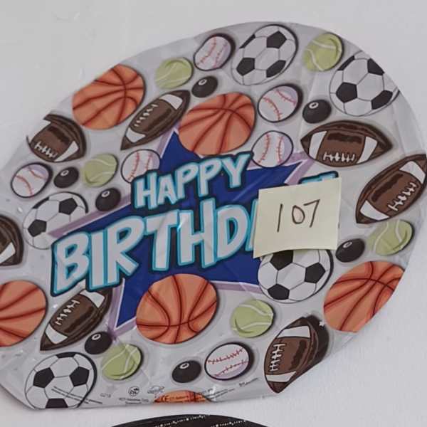 Round birthday balloon with sports balls and "Happy Birthday" text