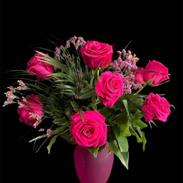Hot pink roses arranged in a pink vase