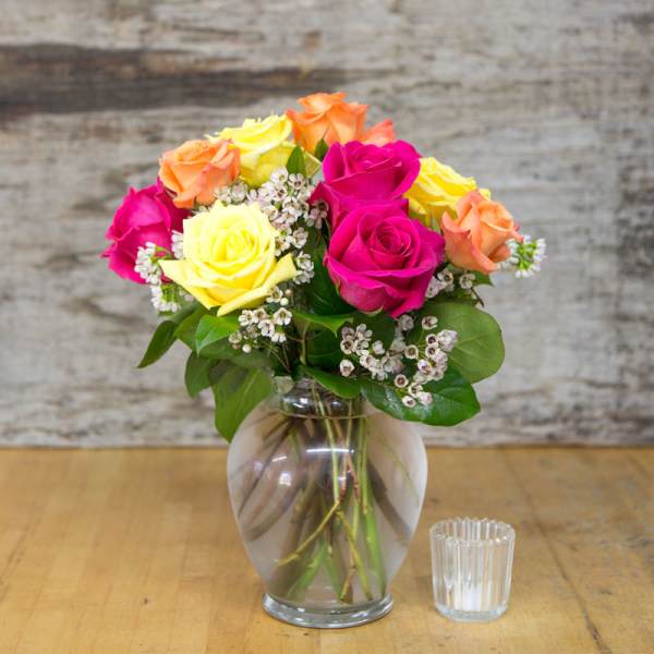 Bouquet of multicolored roses in a glass vase