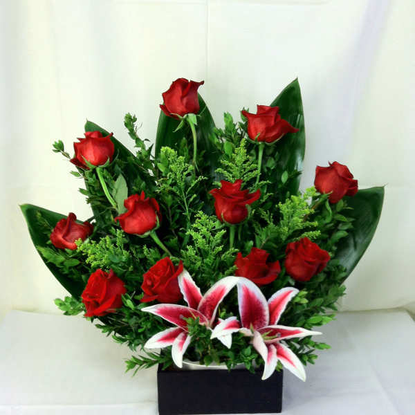 Red roses and pink-white lilies in a black rectangular box