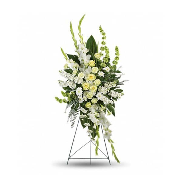 Tall white and pale yellow funeral spray on a standing easel