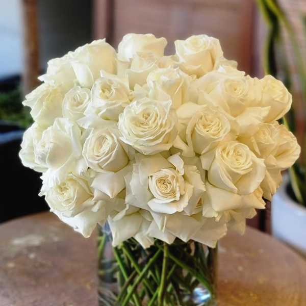 White rose bouquet in a clear glass vase