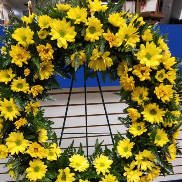 Yellow daisy wreath on a black easel