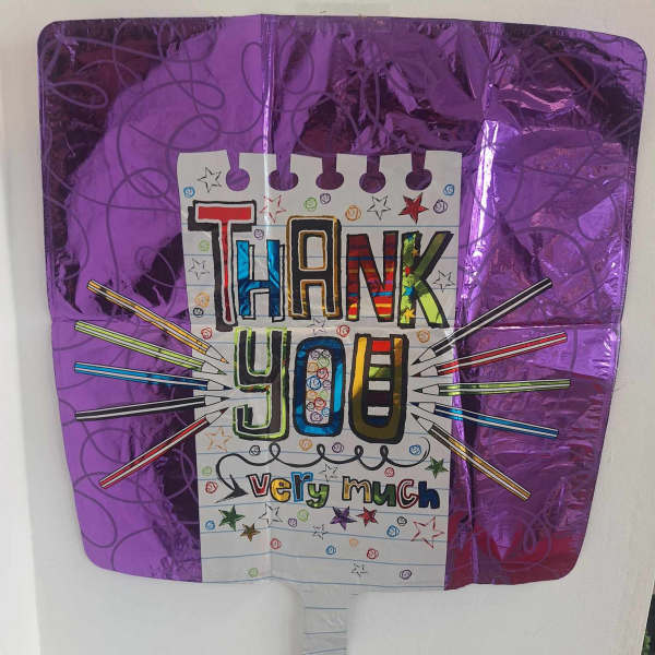 Purple thank-you balloon with colorful hand-drawn lettering