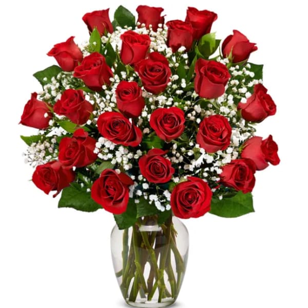 Bouquet of red roses and baby's breath in a clear glass vase