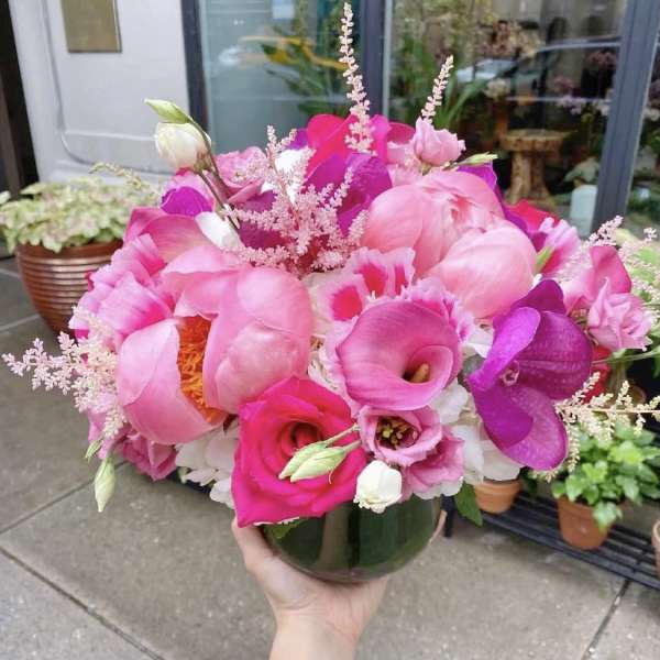 Pink bouquet with calla lilies, roses, and peonies in a glass vase
