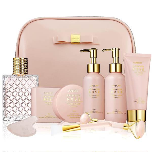 Blush pink rose-scented bath and skincare gift set arranged in front of a matching cosmetic bag.