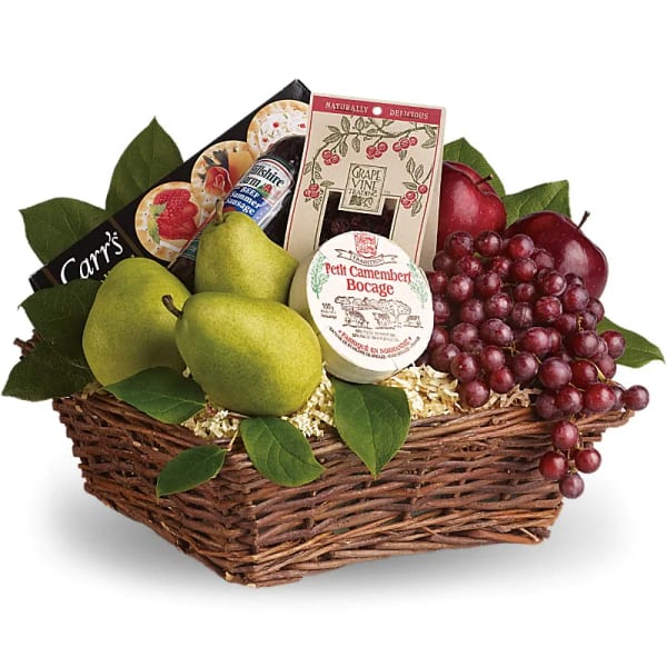 Gift basket with pears, grapes, cheese, and crackers in a wicker basket