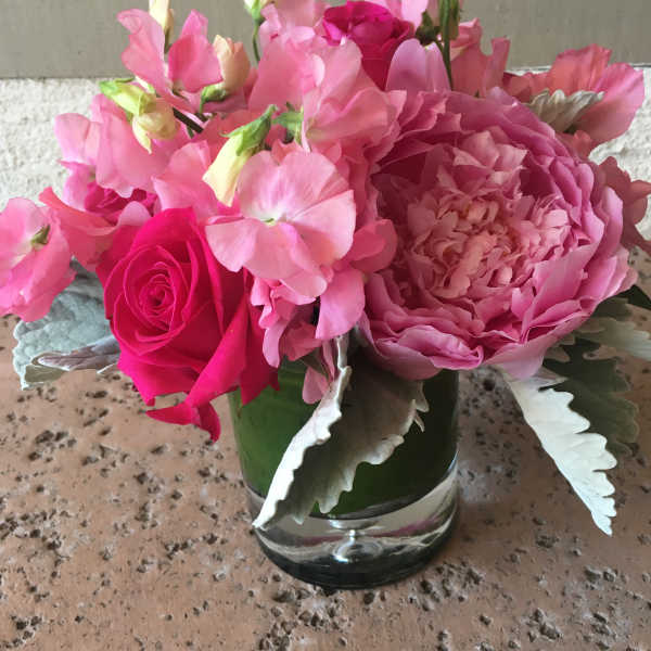 Pink bouquet with a rose and peony in a clear glass vase