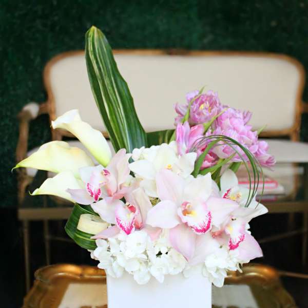 Pink and white floral arrangement in a white vase