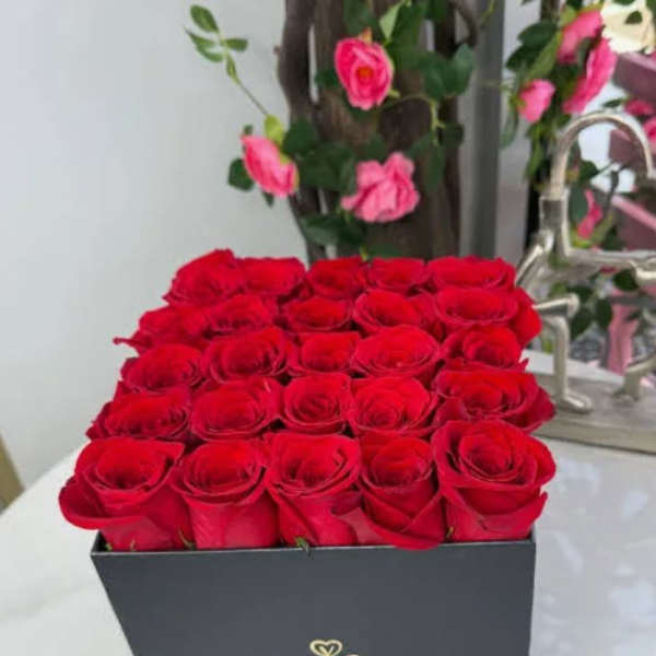 Box of red roses with a black ribbon