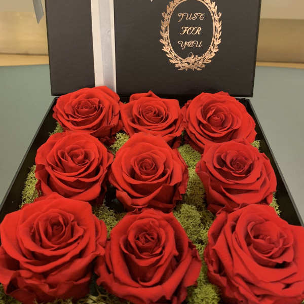 Box of red roses with a white ribbon and bow