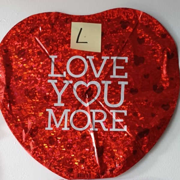 Red heart-shaped balloon with "LOVE YOU MORE" text