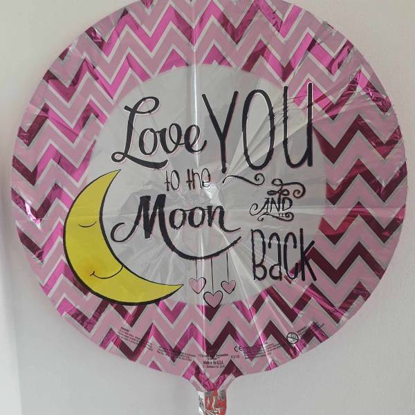 Round pink foil balloon with "Love You to the Moon and Back" text