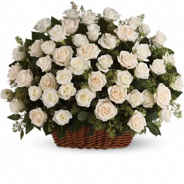 Basket of white roses with soft peach accents