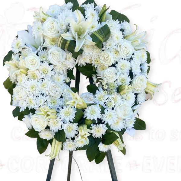White floral wreath on a standing easel