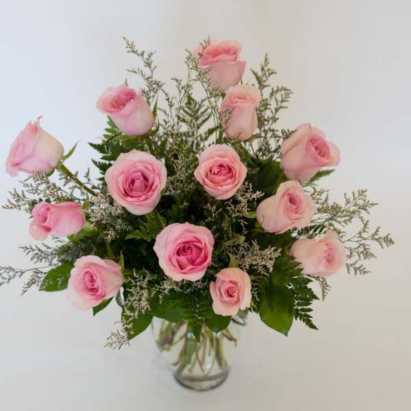 Pink roses arranged in a clear glass vase