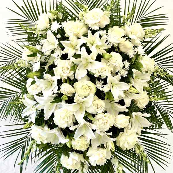 White floral standing spray with roses and lilies