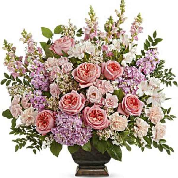 Pink roses and lavender flowers arranged in a dark vase