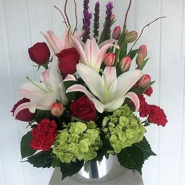 Bouquet of lilies, roses, tulips, and hydrangeas in a vase