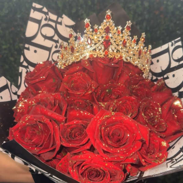 Bouquet of red roses with a jeweled crown and black-and-white wrapping