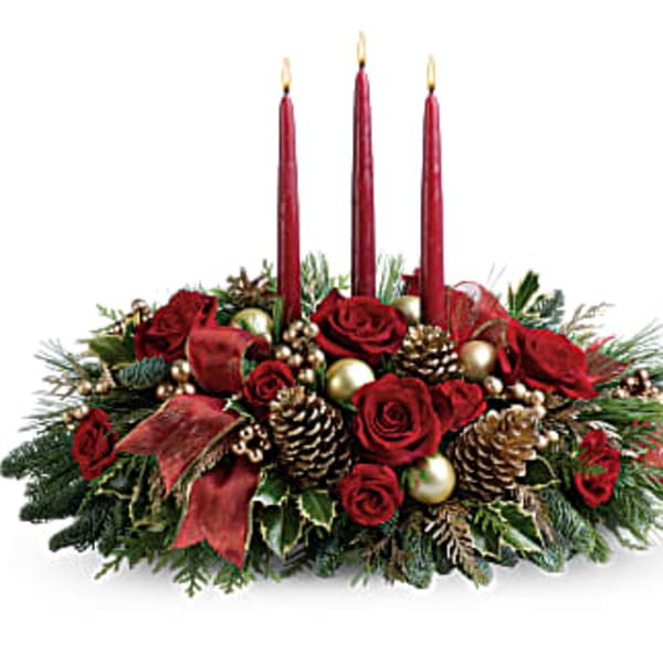 Holiday centerpiece with red roses, candles, pinecones, and gold ornaments