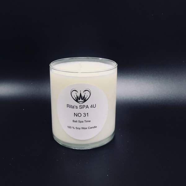 White soy wax candle in a clear glass jar with a printed label