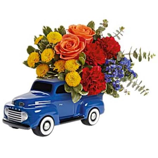 Blue toy truck holding a colorful flower arrangement