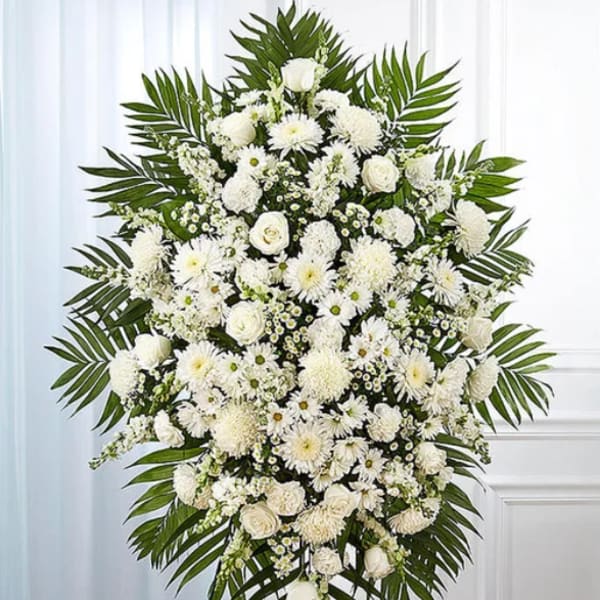 White funeral spray with roses and daisies on a standing easel