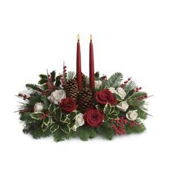 Holiday centerpiece with red candles, roses, and pinecones