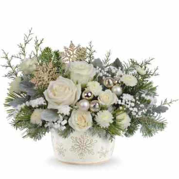 White roses in a decorated holiday container with silver ornaments