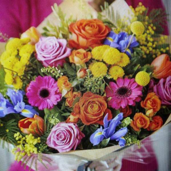 Mixed bouquet of roses, daisies, and yellow pom flowers