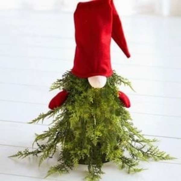 Red velvet gnome figure with a long green mossy skirt