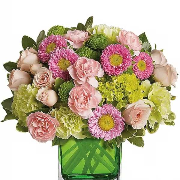 Pink and green mixed bouquet in a square glass vase