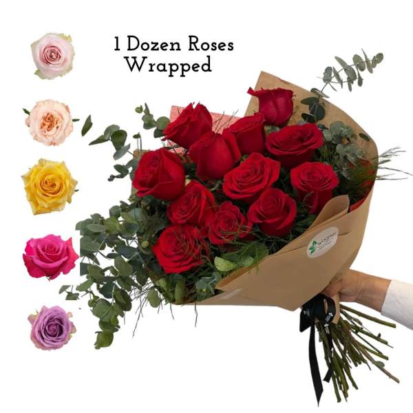 Bouquet of red roses wrapped in brown paper with eucalyptus