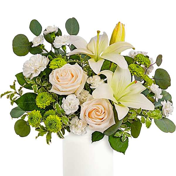 White lilies and cream roses in a white vase with green accents