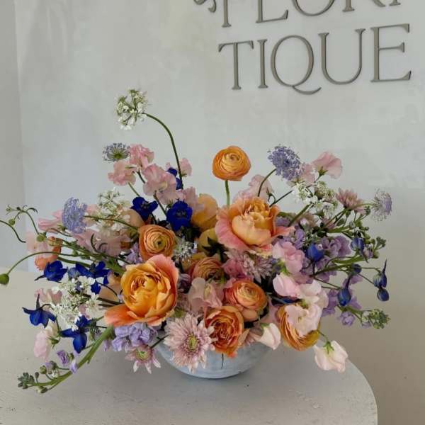 Mixed pastel bouquet in a low white vase