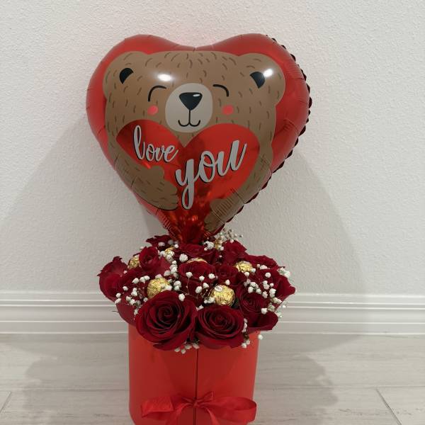 Red rose arrangement in a red box with a heart-shaped teddy bear balloon