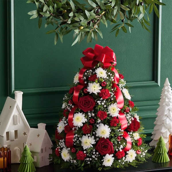Cone-shaped floral arrangement with red ribbon and white daisies