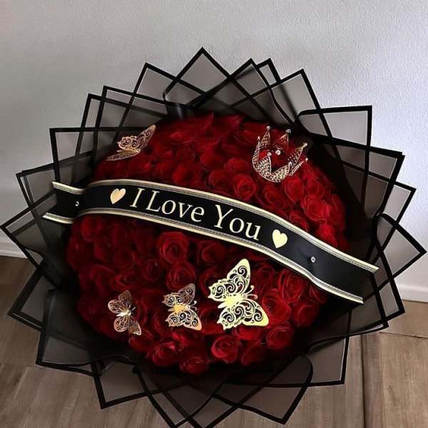 Large bouquet of red roses with a black "I Love You" ribbon