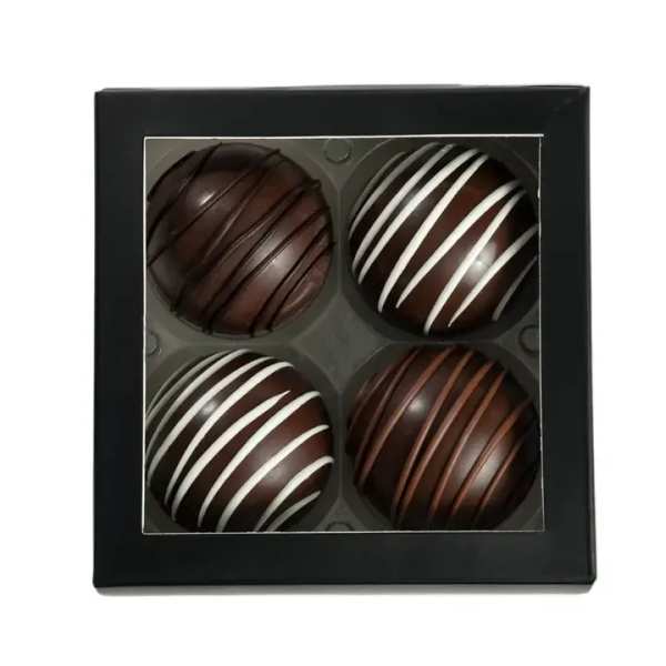 Box of four chocolate truffles with striped drizzle
