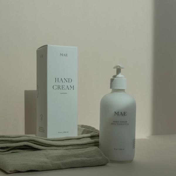 Hand cream bottle and box on folded cloth
