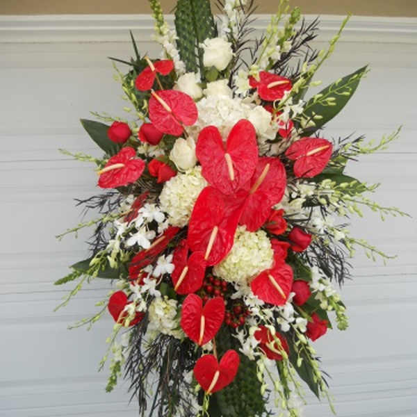 Tall standing spray with red anthuriums and white flowers