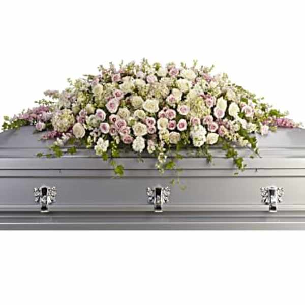 White casket spray with pale pink flowers